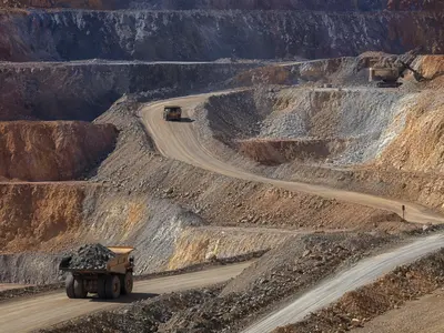 Dump trucks hauling material out of an open-pit copper mine. 