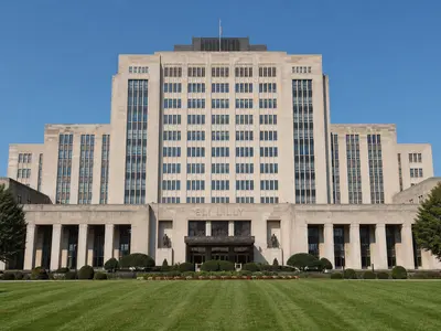A wide front-on daylight shot of the Eli Lilly corporate headquarters building in Indianapolis, its name visible incidentally on the facade above the entrance.