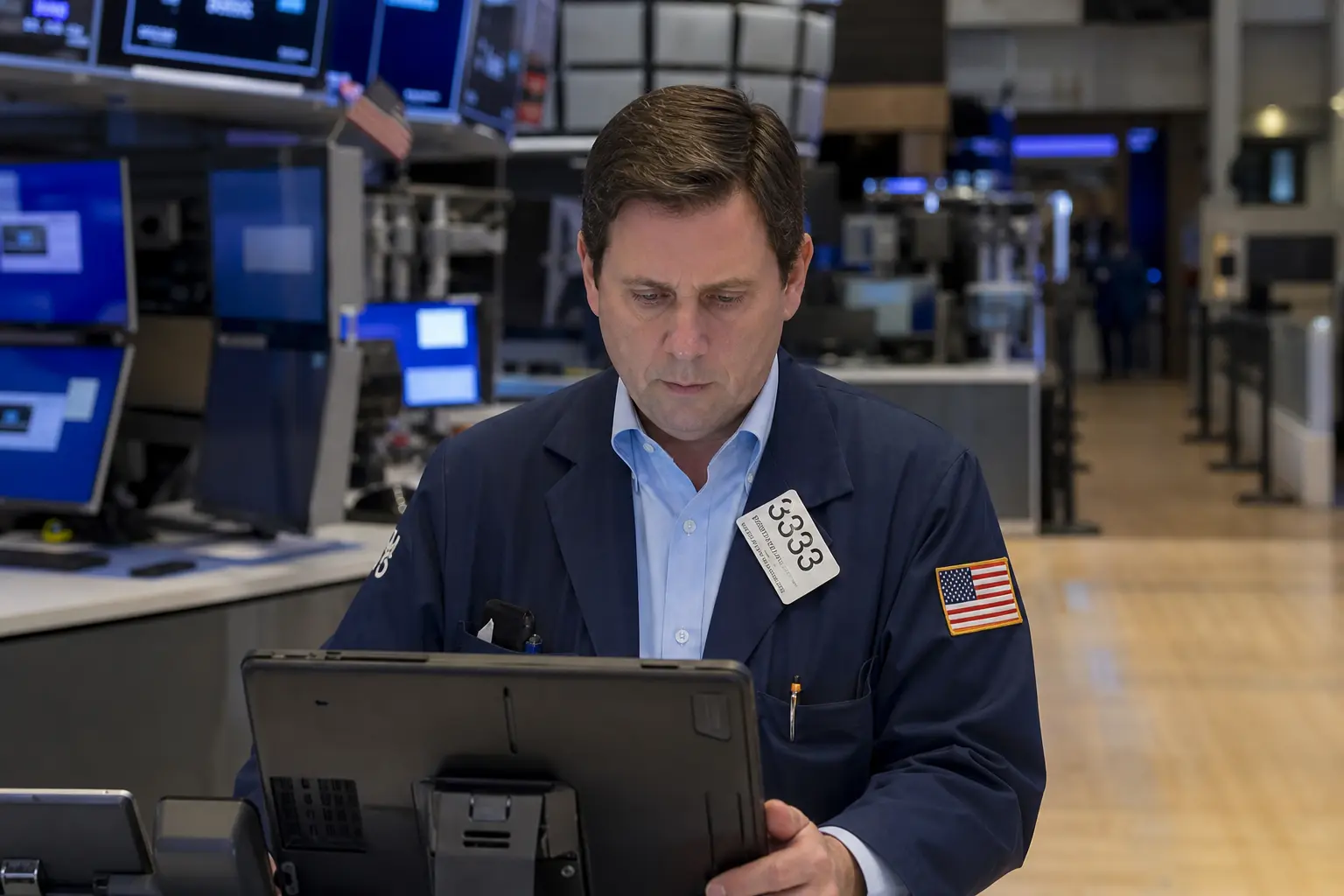 A trading floor at the New York Stock Exchange seen straight-on in ordinary daylight, with traders at their terminals during a working session.