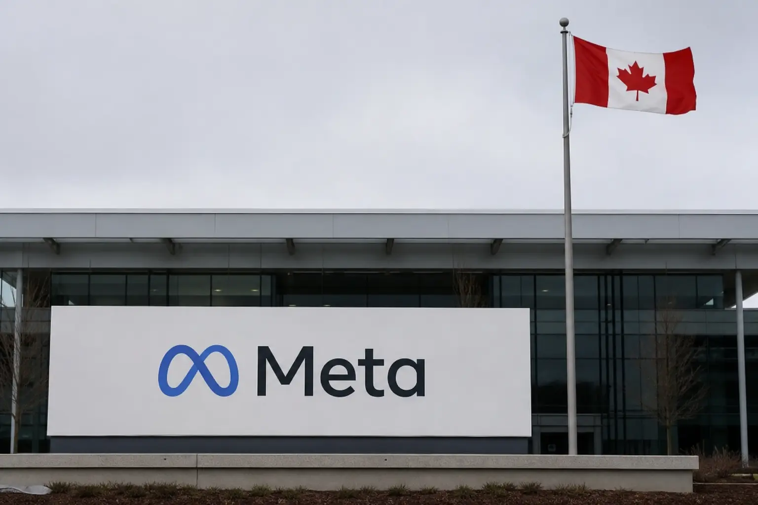 A straight-on exterior view of Meta's building entrance sign in daylight with a Canadian flag on a flagpole beside it against a plain overcast sky.