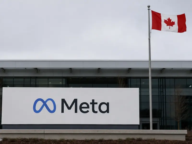 A straight-on exterior view of Meta's building entrance sign in daylight with a Canadian flag on a flagpole beside it against a plain overcast sky.